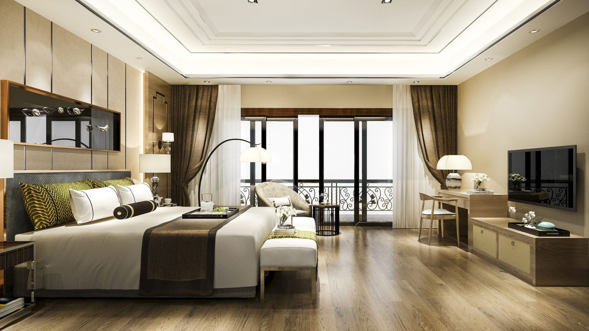 A modern, spacious bedroom with a large bed, wooden floors, a flat-screen TV, and a desk. There is also a balcony with curtains.