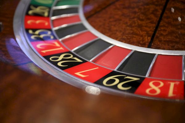 The image shows a portion of a roulette wheel, displaying black, red, and green numbered segments commonly found in casinos.