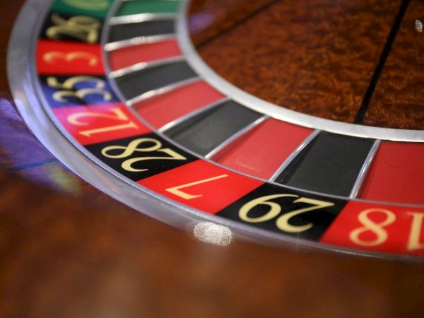 The image shows a portion of a roulette wheel, displaying black, red, and green numbered segments commonly found in casinos.