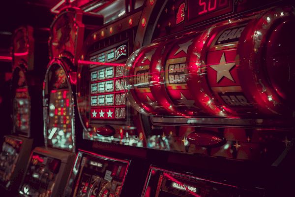 It's an image of illuminated slot machines in a casino, featuring symbols like 