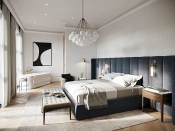 A modern bedroom with a large bed, elegant chandelier, two bedside tables, a bench, and a bathtub by the window, featuring minimal decor.