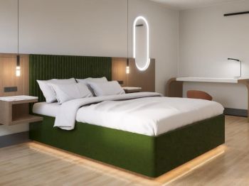 A modern bedroom with a green-accented bed, built-in lights, and a wooden desk. The room features minimalist decor and soft lighting.