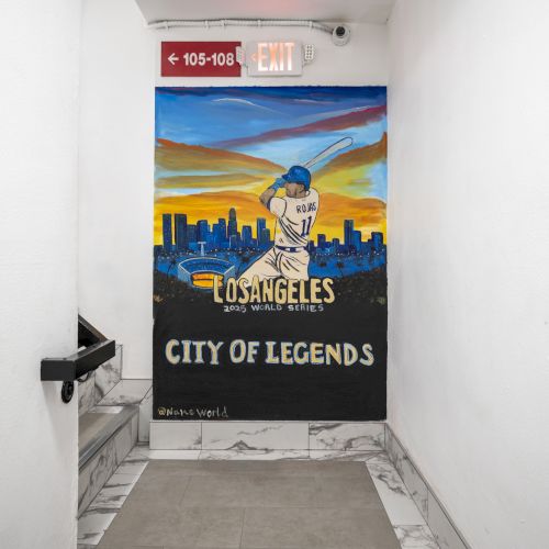 A hallway banner shows a Dodgers-style baseball scene: &ldquo;Los Angeles City of Legends,&rdquo; with an exit sign above.